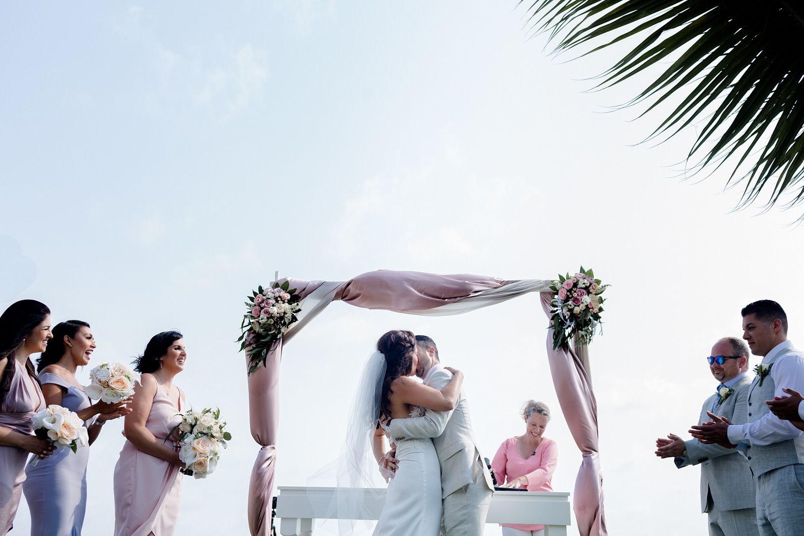 wedding-ceremony-kiss-vallarta-bride-groom-claps-sky-beach wedding