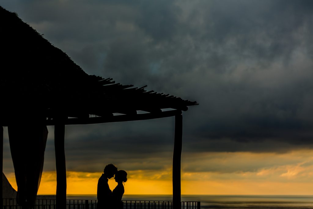 wedding silouette bride groom sunset orange sky clouds ocean roof Vallarta  mismaloya 