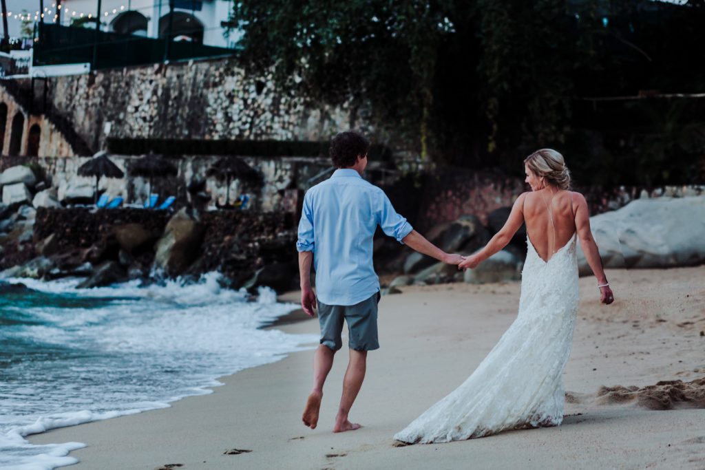 wedding beach Vallarta mismaloya bride groom walking sand rocks look ocean wave 