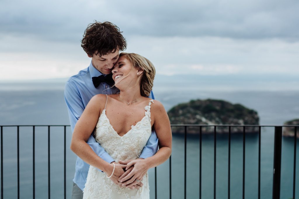 wedding bride groom hug smile los arcos ocean Vallarta mismaloya 