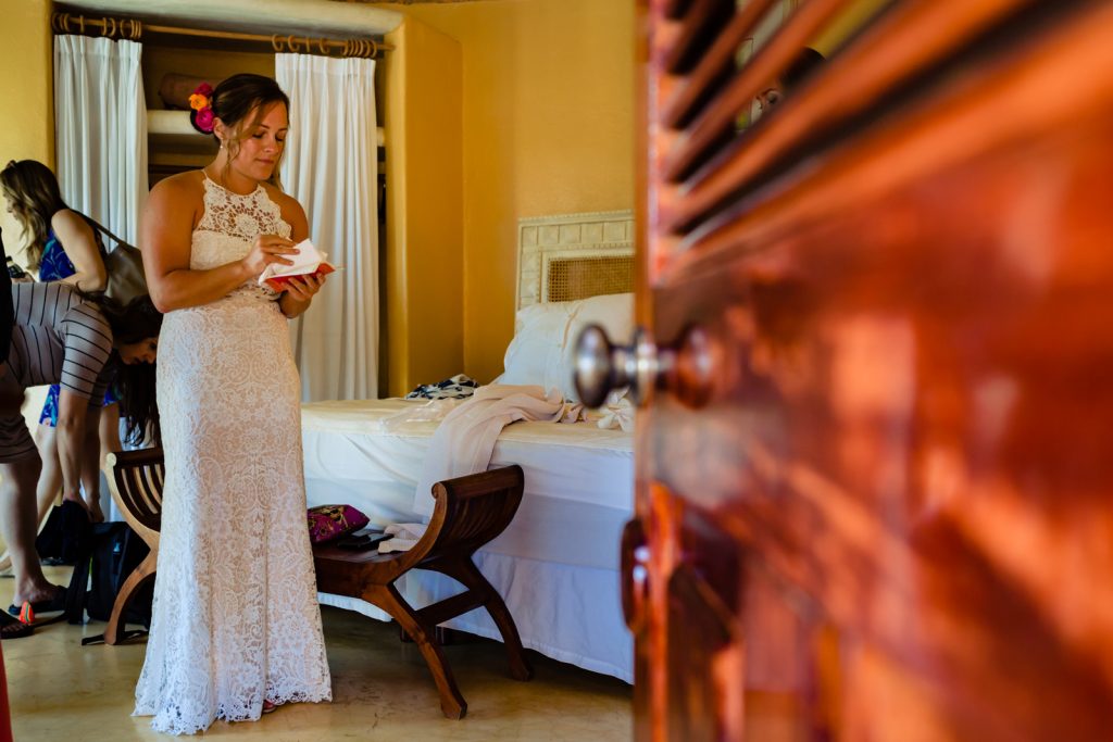 bride riding the vows  before the ceremony in her hotel room almost ready to getting married 