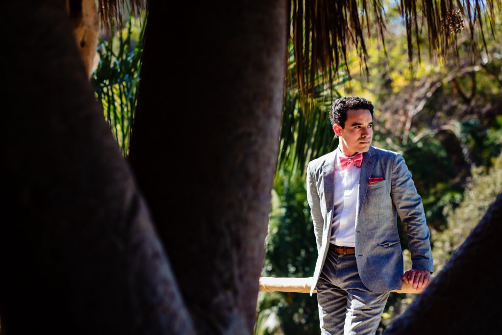 groom outside looking at the ocean ready for getting married 