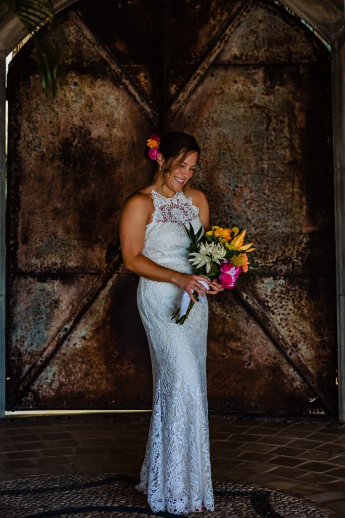 bride portraits with flowers by a rusty door just before the ceremony 