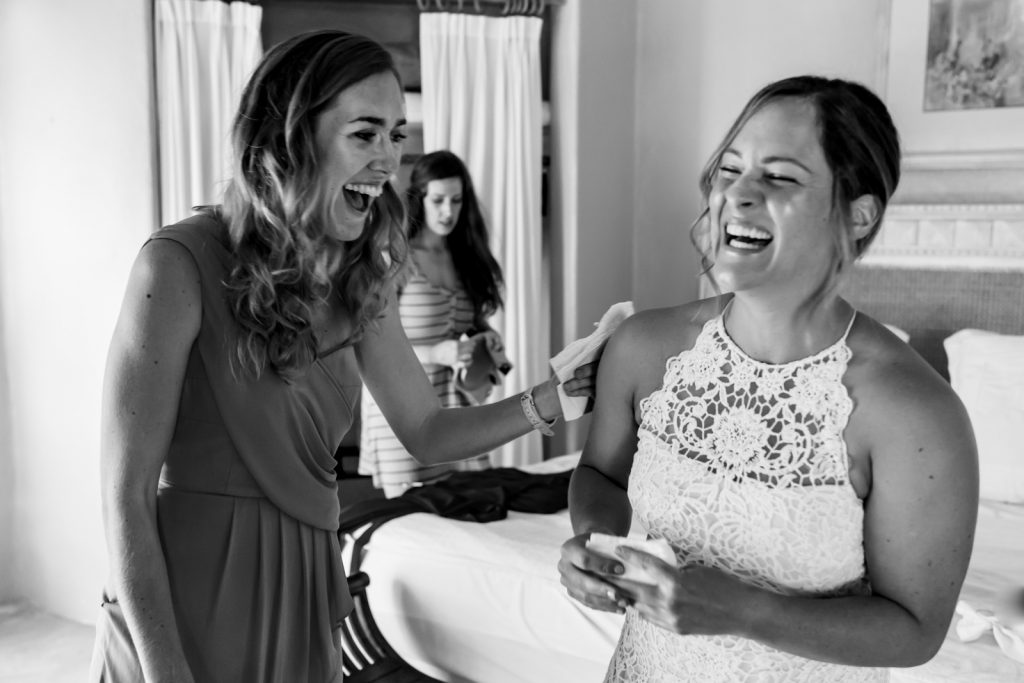 bride and bridesmaid smile before the ceremony 