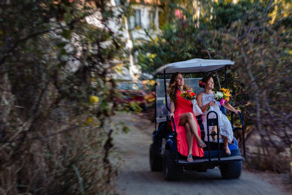 bride and bridesmaid going on golf cart and have fun