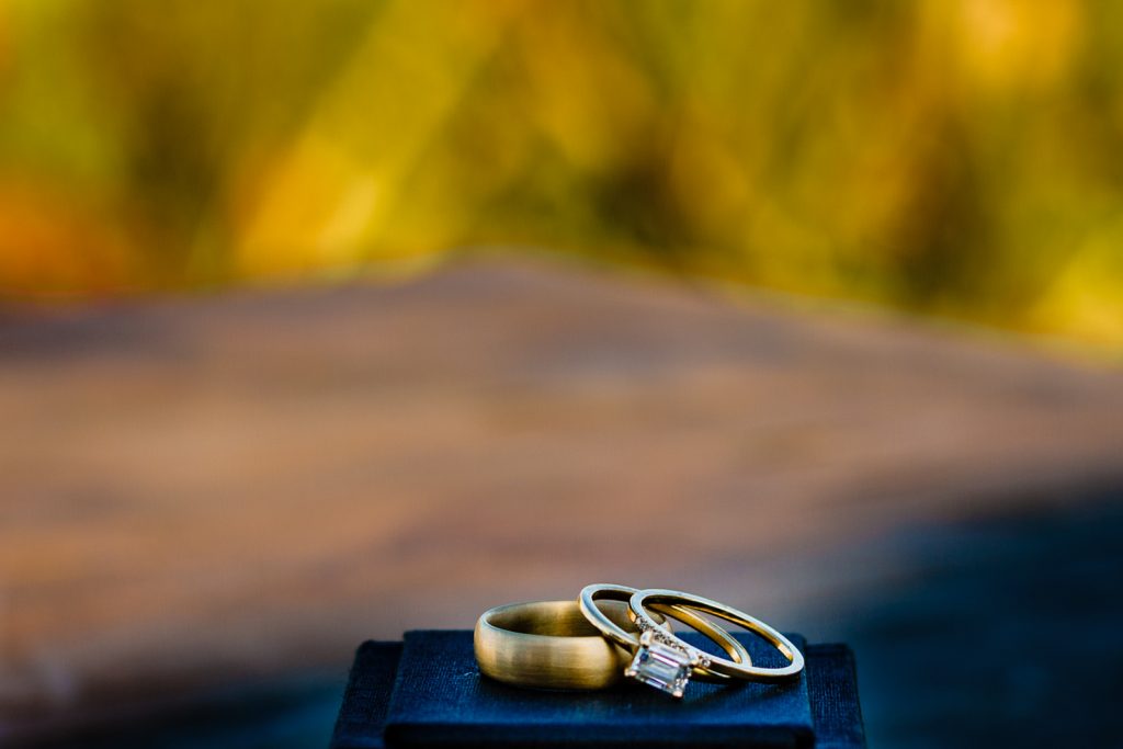 wedding rings at the top of a little box 