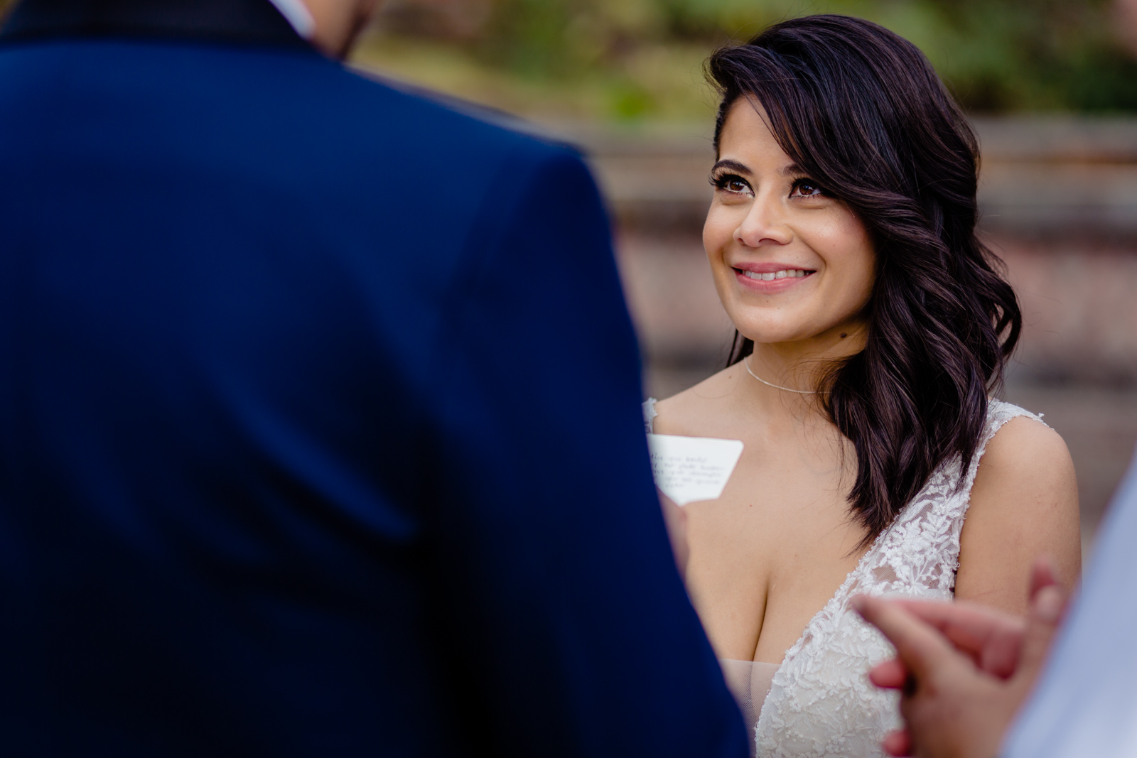 bride during the ceremony look at the groom reading his vals 