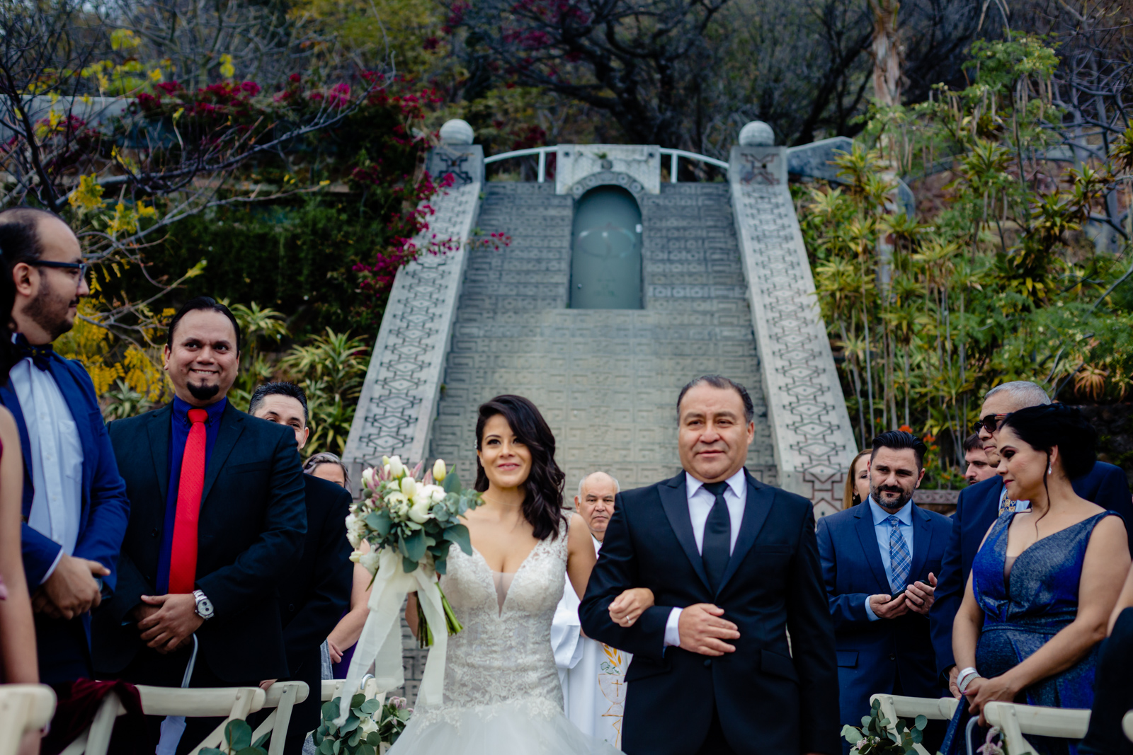 wedding ceremony, bride arrive with her dad and all the guest looking at her 