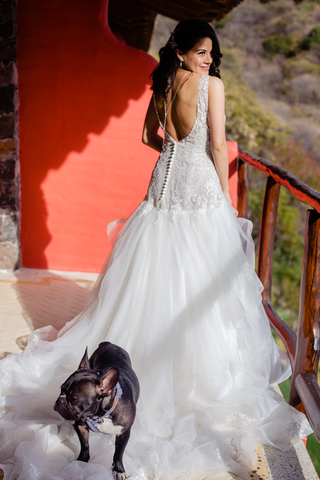 bride ready before the ceremony with the dog on the dress 