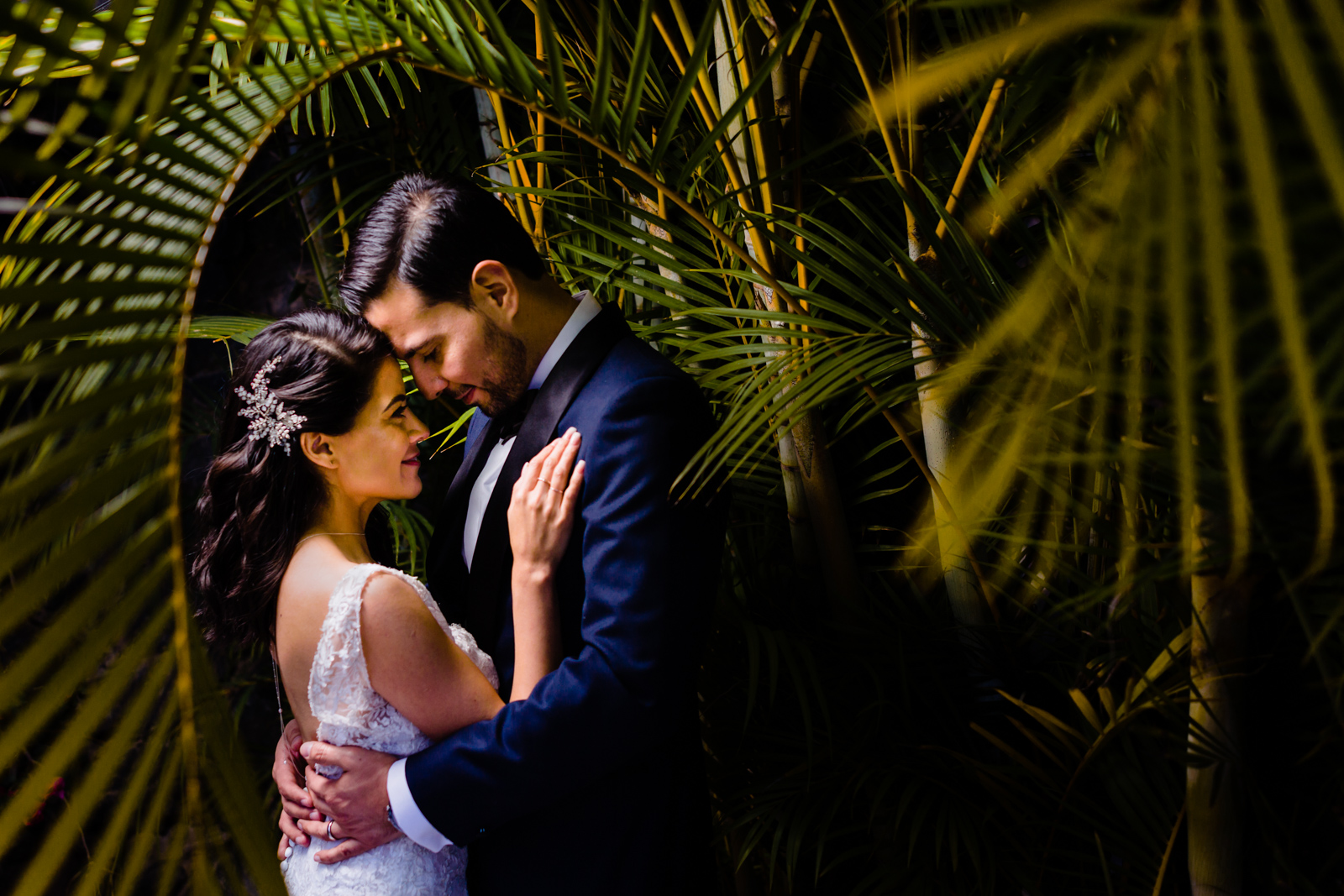 bride and groom hugs on a garden in the middle of the green