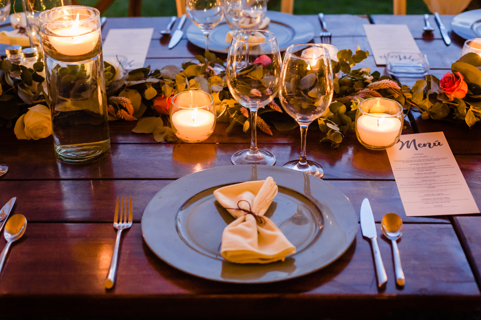 set up of the table with candles plates and menu'