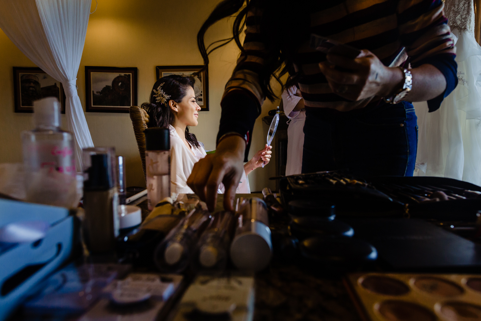 bride gettin ready before the ceremony, make up and looking at the mirror 