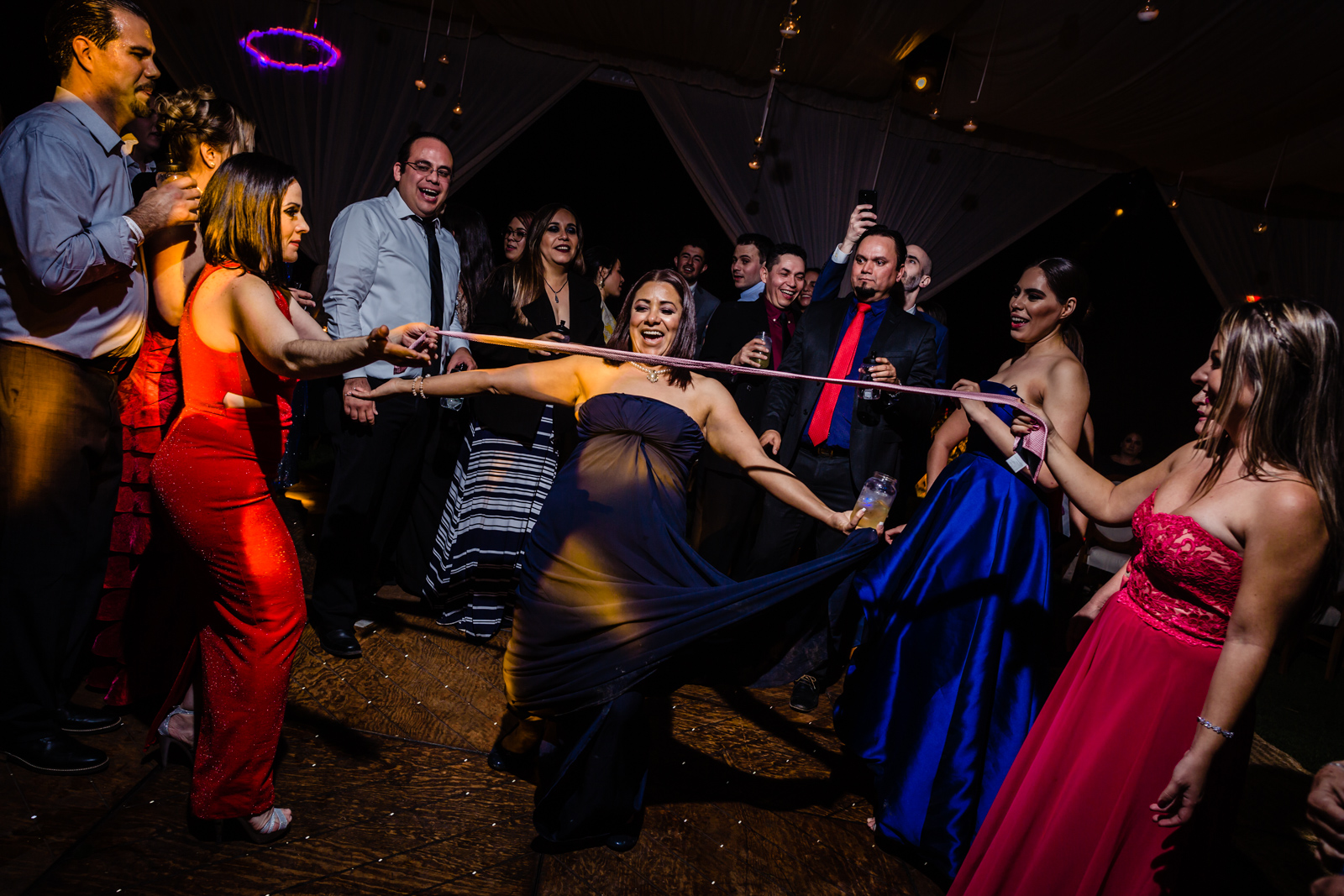 girls having fun on the dance floor play with the tie 