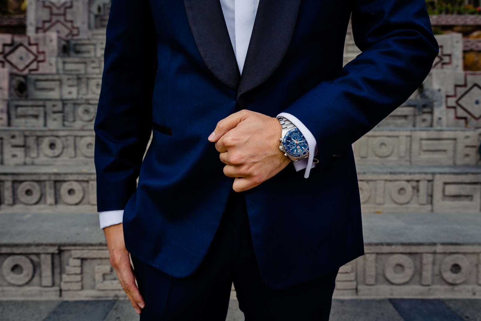 groom details, suit and clock, hands on the pocket 