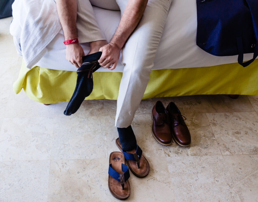 groom put his sox on it sit in on the bed 