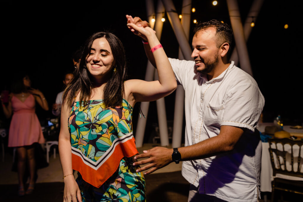 couple dance together on the dance floor of the Hilton hotel both smile 