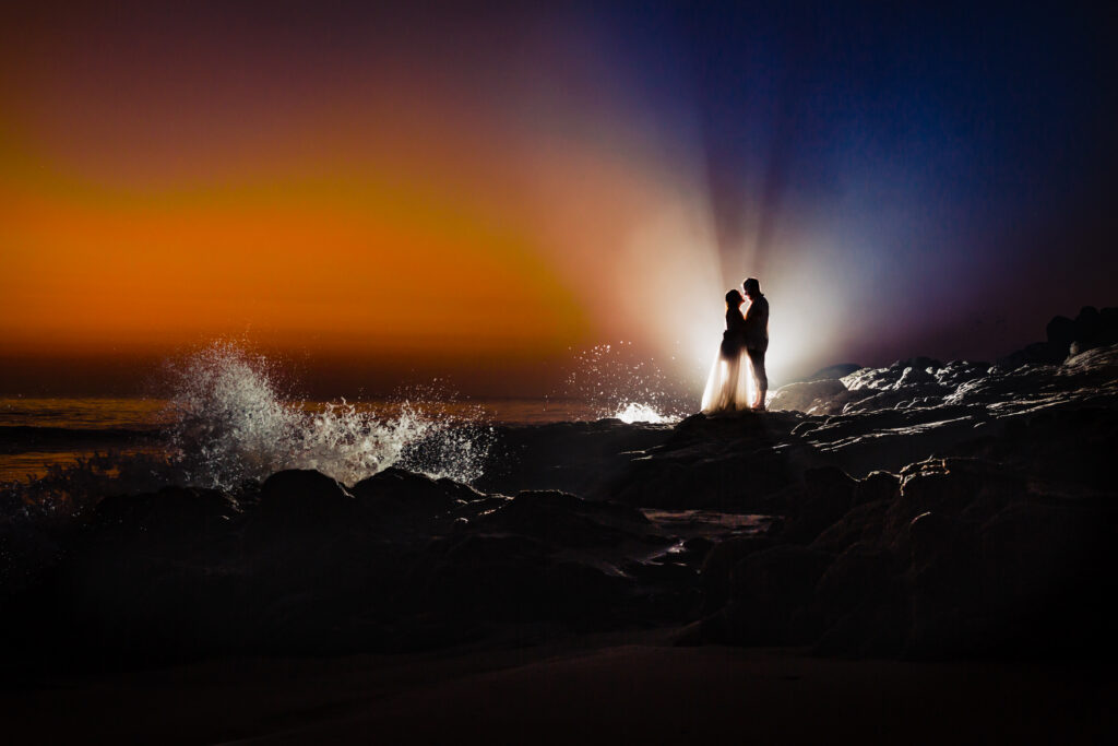 siluette of bride and groom during the sunset time with a colorful sky on their background 